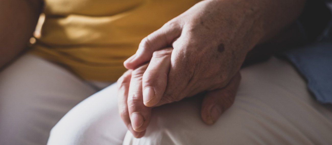 hospice-caregiver-holding-a-patient's-hand