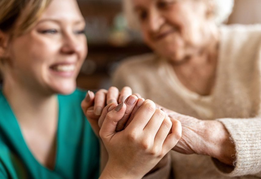 hospice-nurse-grasping-patient's-hand