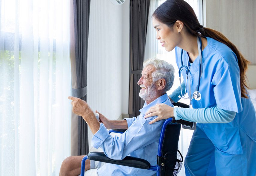 hospice-nurse-looking-out-the-window-with-patient
